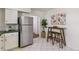 Kitchen featuring a modern refrigerator, black counters, and a small dining area at 4353 Sherman St, Denver, CO 80216