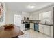 Bright kitchen with white cabinets, stainless steel appliances, and dining area at 4353 Sherman St, Denver, CO 80216