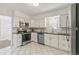Bright kitchen with white cabinets, stainless steel appliances, and modern fixtures at 4353 Sherman St, Denver, CO 80216