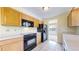 Bright kitchen with oak cabinets and modern appliances at 7338 W Lakeside Dr, Littleton, CO 80125