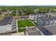 A birdseye view of modern townhomes situated around a vibrant central lawn and community pavilion at 397 East St, Louisville, CO 80027
