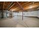 Unfinished basement with visible wood beams and concrete floor provides a blank canvas for customization at 397 East St, Louisville, CO 80027