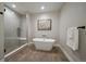 Modern bathroom boasts a freestanding tub, sleek glass shower, and stylish tile flooring at 397 East St, Louisville, CO 80027