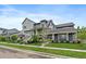 Stunning gray house with lush green lawns, and welcoming front porches at 397 East St, Louisville, CO 80027