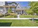 Beautiful gray home with a manicured lawn and covered front porch, perfect for relaxing outdoors at 397 East St, Louisville, CO 80027