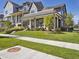 Charming two-story gray home featuring a covered porch and well-maintained lawn at 397 East St, Louisville, CO 80027