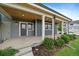 Inviting porch with wood ceiling, and landscaping providing a warm and welcome entrance at 397 East St, Louisville, CO 80027
