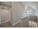 Well-lit hallway with carpet flooring, neutral paint, and a view of the staircase and a window at 397 East St, Louisville, CO 80027