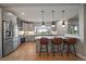 Well-appointed kitchen with gray cabinets, stainless steel appliances, and a breakfast bar with seating at 397 East St, Louisville, CO 80027