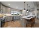 Modern kitchen features gray cabinets, stainless steel appliances, and a bright window with outdoor views at 397 East St, Louisville, CO 80027