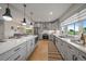Contemporary kitchen boasting a large island, stainless steel appliances, and open layout connecting to dining area at 397 East St, Louisville, CO 80027