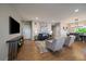 Bright living room with hardwood floors, a cozy sofa, stylish chairs, and a modern entertainment center at 397 East St, Louisville, CO 80027