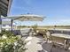 Spacious outdoor deck with an umbrella, seating, plants, and expansive views of the surrounding landscape at 397 East St, Louisville, CO 80027