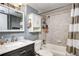 Cozy bathroom features a vanity with marble countertop, tiled shower/tub combo, and extra storage at 4833 S Pitkin Ct, Aurora, CO 80015