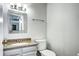 Clean half bathroom featuring a granite counter vanity and modern fixtures at 4833 S Pitkin Ct, Aurora, CO 80015