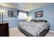Bedroom with light-blue painted walls, natural light, and neutral carpet at 4833 S Pitkin Ct, Aurora, CO 80015