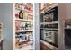 Convenient kitchen pantry and built-in double oven appliance at 4833 S Pitkin Ct, Aurora, CO 80015