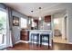 Charming dining area near a refreshed kitchen featuring counter seating and modern stainless steel appliances at 4833 S Pitkin Ct, Aurora, CO 80015