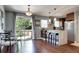 Dining area with an open layout to a kitchen featuring a breakfast bar and modern lighting at 4833 S Pitkin Ct, Aurora, CO 80015