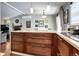 Open kitchen layout with rich wood cabinetry, granite counters, and seamless flow to living spaces at 4833 S Pitkin Ct, Aurora, CO 80015