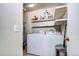 Functional laundry room with washer, dryer, and shelving at 4833 S Pitkin Ct, Aurora, CO 80015