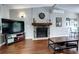 Cozy living room features a stone fireplace, hardwood floors, and plenty of natural light at 4833 S Pitkin Ct, Aurora, CO 80015