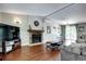 Cozy living room boasts a stone fireplace, hardwood floors, and an open layout at 4833 S Pitkin Ct, Aurora, CO 80015
