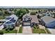 Aerial view of a charming two-story home in a well-developed suburban neighborhood with mature trees at 16352 E 104Th Way, Commerce City, CO 80022