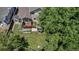 Backyard aerial view of the property showcasing the deck, garden, patio and mature trees at 16352 E 104Th Way, Commerce City, CO 80022