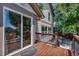 Large wooden deck with sliding glass doors, perfect for outdoor entertaining and relaxation at 16352 E 104Th Way, Commerce City, CO 80022