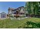 Large backyard featuring a garden, deck, and storage shed, offering ample outdoor space at 16352 E 104Th Way, Commerce City, CO 80022