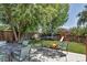 Spacious backyard with a fire pit, playground, and trampoline, perfect for entertaining and play at 16352 E 104Th Way, Commerce City, CO 80022