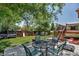 Expansive backyard featuring a patio with dining set and a swing set for outdoor enjoyment at 16352 E 104Th Way, Commerce City, CO 80022