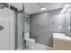 Modern bathroom with sleek glass-enclosed shower, stylish tiling, and updated fixtures at 16352 E 104Th Way, Commerce City, CO 80022