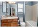 Bathroom featuring a vanity with sink, toilet, and tub shower at 16352 E 104Th Way, Commerce City, CO 80022