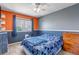 Spacious bedroom with large windows, grey carpet, and colorful decor at 16352 E 104Th Way, Commerce City, CO 80022