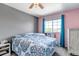 Bright bedroom with a ceiling fan, a large window with curtains, and carpet flooring at 16352 E 104Th Way, Commerce City, CO 80022
