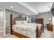 Cozy bedroom with soft lighting, carpet flooring, and wrought iron bed frame at 16352 E 104Th Way, Commerce City, CO 80022