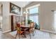 Elegant dining room with a large window, rustic wood table, and a statement chandelier at 16352 E 104Th Way, Commerce City, CO 80022