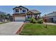 Charming two-story home with a well-manicured lawn and inviting curb appeal in a suburban neighborhood at 16352 E 104Th Way, Commerce City, CO 80022