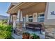 Inviting front porch with comfortable seating and charming decor, perfect for relaxing outdoors at 16352 E 104Th Way, Commerce City, CO 80022