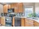 Updated kitchen with stainless appliances, stylish backsplash, and granite countertops at 16352 E 104Th Way, Commerce City, CO 80022