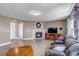 Spacious living room featuring a fireplace and large windows offering plenty of natural light at 16352 E 104Th Way, Commerce City, CO 80022