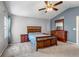 Main bedroom featuring vaulted ceiling, ceiling fan, and dark wood furniture set at 16352 E 104Th Way, Commerce City, CO 80022