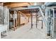 Unfinished basement featuring concrete floors, utility infrastructure, and exposed ceiling beams at 7476 E Arkansas Ave # 35-10, Denver, CO 80231