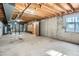 Spacious unfinished basement with concrete floors, exposed beams, and a window at 7476 E Arkansas Ave # 35-10, Denver, CO 80231