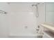 Bathroom featuring a shower-over-tub with white tiling and shower head at 7476 E Arkansas Ave # 35-10, Denver, CO 80231