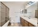 Bathroom featuring a bathtub, toilet, vanity, and large mirror at 7476 E Arkansas Ave # 35-10, Denver, CO 80231