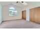 Bedroom with a large window and two closets, offering ample storage space at 7476 E Arkansas Ave # 35-10, Denver, CO 80231