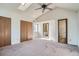Bedroom with large closets, ceiling fan, and ensuite bathroom access at 7476 E Arkansas Ave # 35-10, Denver, CO 80231